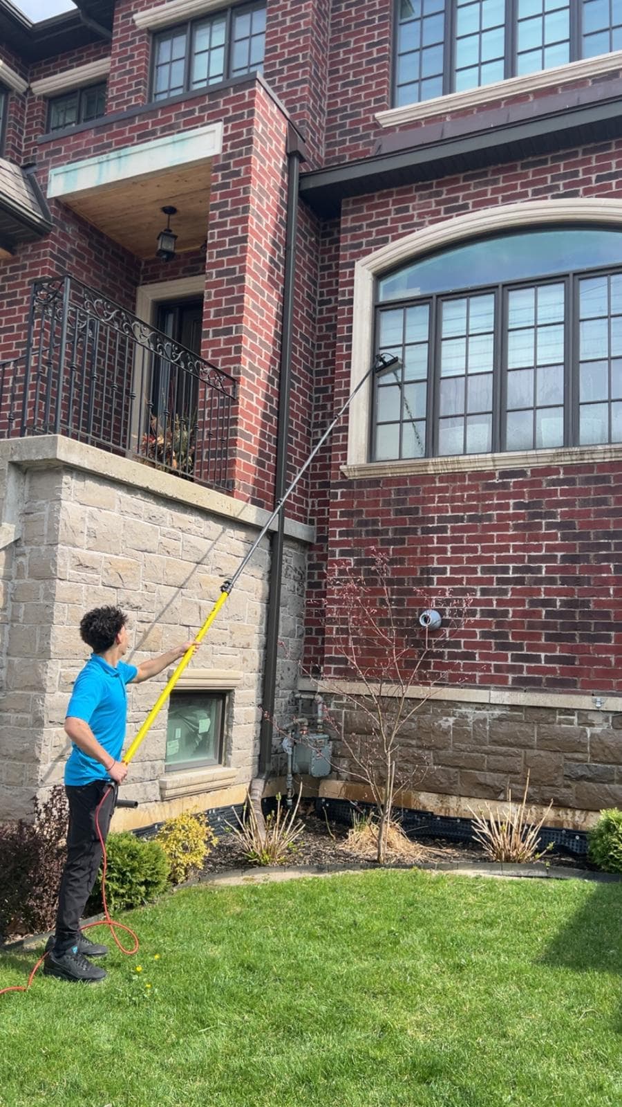 Professional window cleaning technician at work in Toronto home